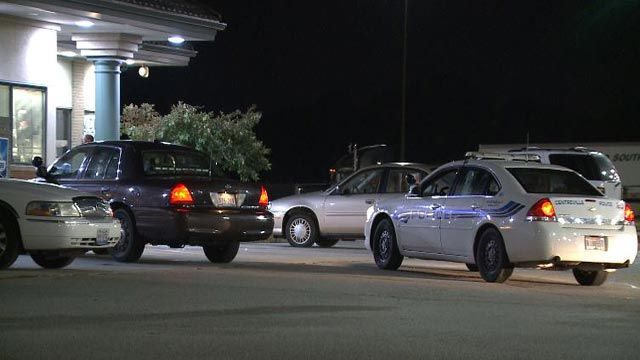 Police outside the Flying J Truck Stop on Race Horse Drive after an officer was dragged by a suspect vehicle Wednesday (Credit: KMOV)